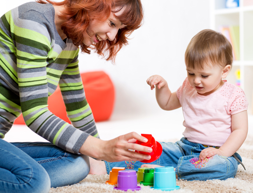 Young mother plays with and teaches her toddler 